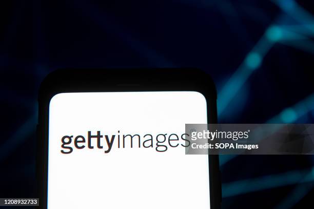 In this photo illustration a Getty Images logo seen displayed on a smartphone.