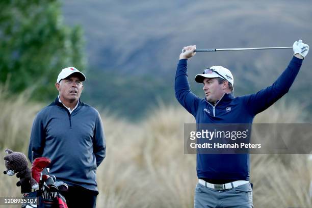 Ryan Fox of New Zealand warms up with his caddie Steve Williams during day one of the 2020 New Zealand Golf Open at The Hills on February 27, 2020 in...