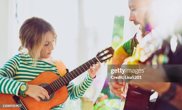 jam session man and child play guitar - music therapy stock pictures, royalty-free photos & images