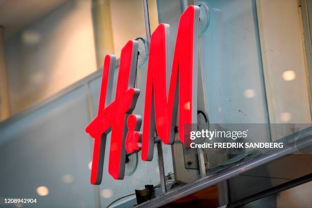 The logo of H & M can be seen at a fashion store of H&M in central Stockholm on April 2, 2020. - Swedish retailer H&M said that the company have...