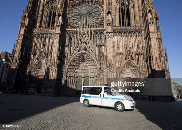 Police officers stand in front of deserted Cathedral square after a strict lockdown in France to stop the spread of the novel coronavirus in central...