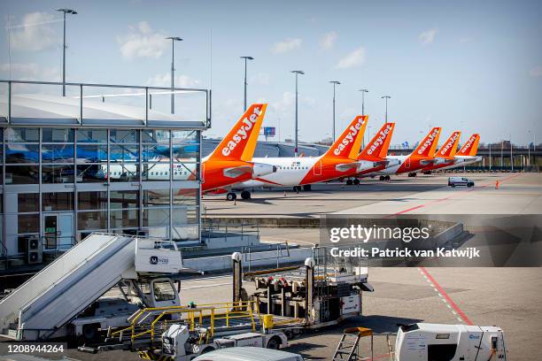 Easyjet airplanes parked at Schiphol airport that closes piers and gates and downsizes the airport to the core of Schiphol during the Coronavirus...