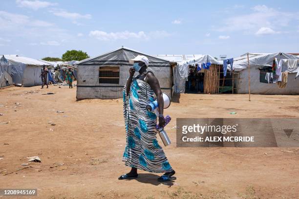 Unicef social mobilizer uses a speaker as she carries out public health awareness to prevent the spread and detect the symptoms of the COVID-19...