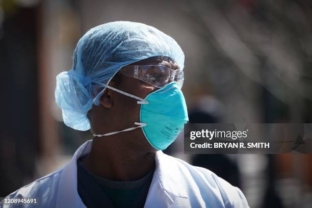 Member of the medical staff listens as Montefiore Medical Center nurses call for N95 masks and other critical PPE to handle the coronavirus pandemic...