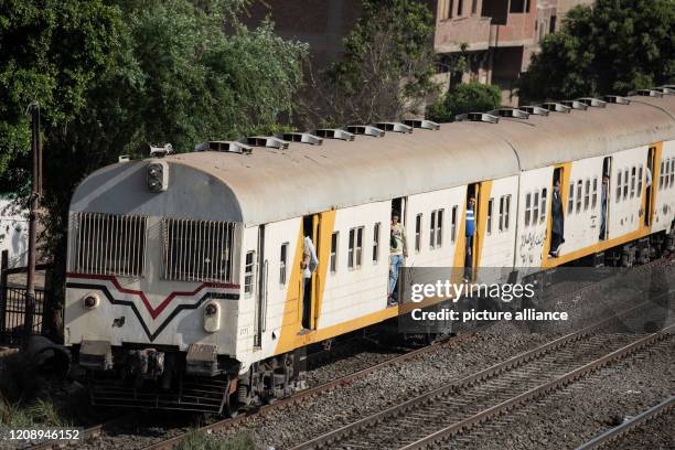 April 2020, Egypt, Cairo: People look out from a crowded train travelling from Cairo to the northern Nile Delta, few hours before the start of a...