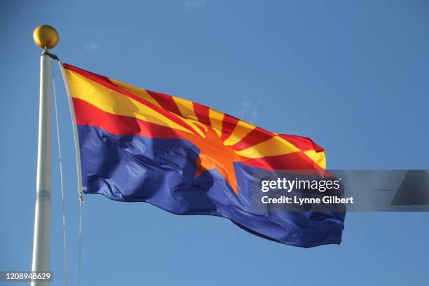 arizona flag flies in the sky by an american flag with a bright blue sky - arizona flag stock pictures, royalty-free photos & images