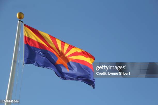 arizona flag flies in the sky by an american flag with a bright blue sky - arizona flag stock pictures, royalty-free photos & images