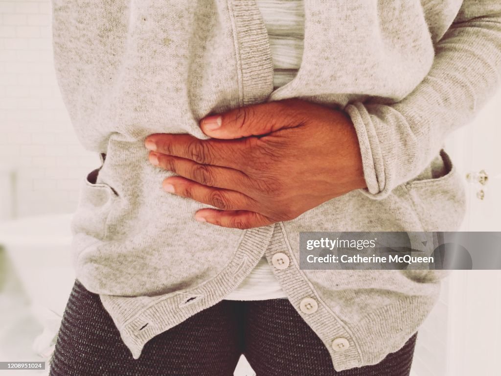 African-american woman experiences stomach pain