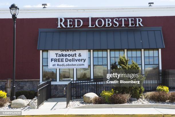 Banner saying "Open For Takeout & Free Delivery" hangs outside a Red Lobster restaurant at The Plaza at Harmon Meadow in Secaucus, New Jersey, U.S.,...