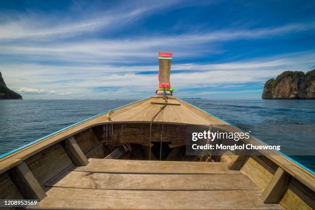 long thai boat into island near railay beach in krabi province near phuket thailand in the andaman sea in south thailand. - kai stock pictures, royalty-free photos & images