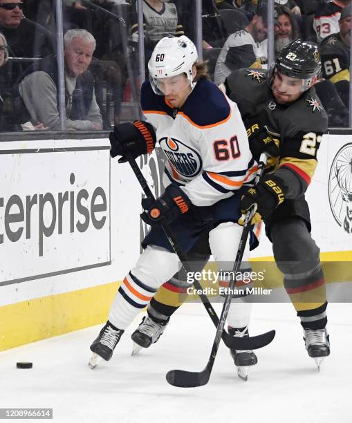 Markus Granlund of the Edmonton Oilers and Alec Martinez of the Vegas Golden Knights fight for the puck in the third period of their game at T-Mobile...