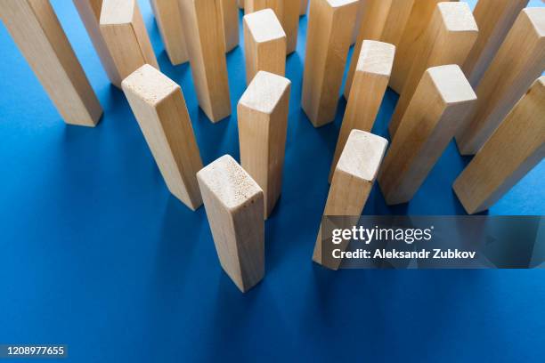 a pile of scattered wooden blocks on a blue background. construction game. the broken tower. - block removal game stock pictures, royalty-free photos & images
