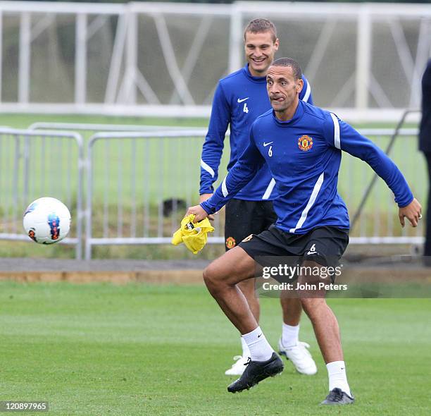 Nemanja Vidic and Rio Ferdinand of Manchester United in action during a first team training session at Carrington Training Ground on August 12, 2011...