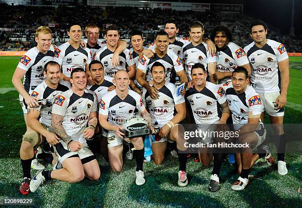Darren Lockyer of the Broncos poses with his team mates after playing his 350th match at the end of the round 23 NRL match between the North...
