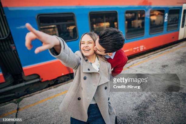 young teenage couple waiting for the train - girls on train track stock pictures, royalty-free photos & images