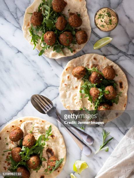 vegan meatballs on flatbreads with hummus dip and rocket leaves. - burger top view stock pictures, royalty-free photos & images