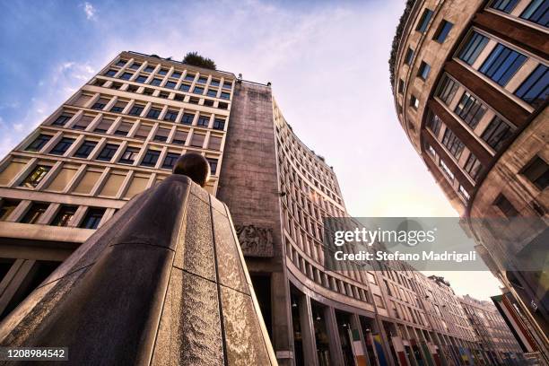 a city street in the urban center of milan with a fountain in the foreground and buildings in the background - milan business stock pictures, royalty-free photos & images