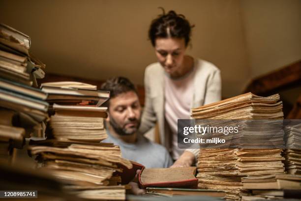 man and women working in library - attic storage stock pictures, royalty-free photos & images