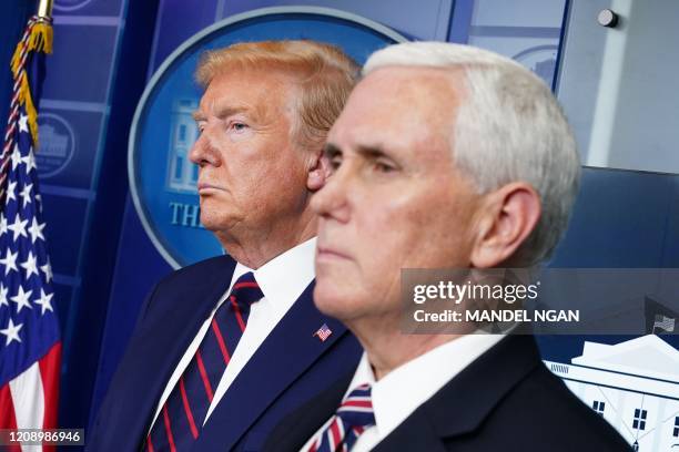 President Donald Trump and US Vice President Mike Pence look on during the daily briefing on the novel coronavirus, COVID-19, in the Brady Briefing...