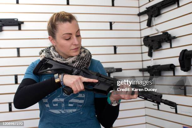 Tiffany Teasdale, owner of Lynnwood Gun, demonstrates a Daniel Defense DD5 semi-automatic rifle on April 2, 2020 in Lynnwood, Washington. Washington...