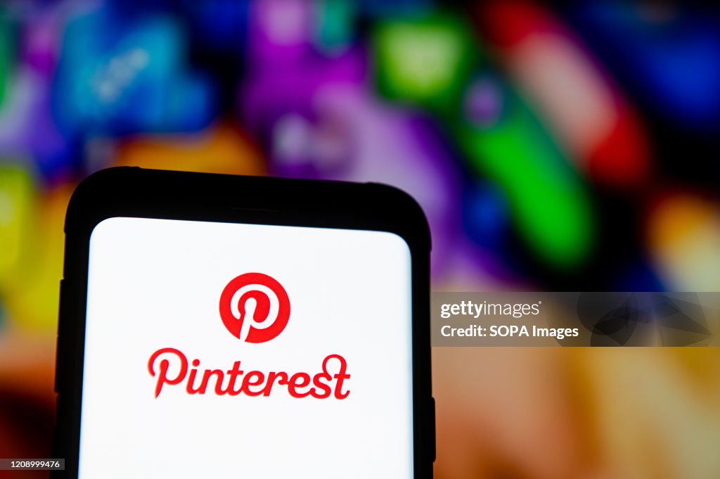 In this photo illustration a Pinterest logo seen displayed...