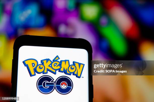 In this photo illustration a Pokemon GO logo seen displayed on a smartphone.