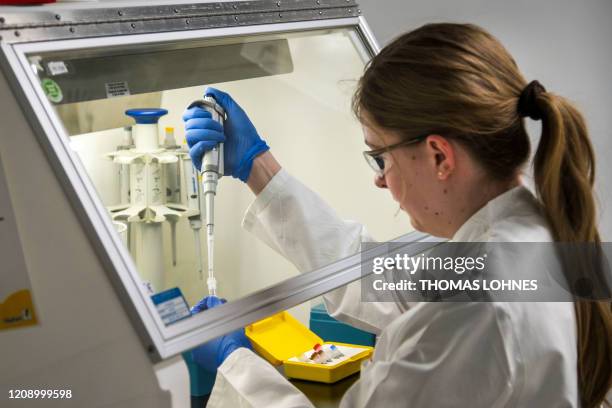 An employee of clinical diagnostics and food & feed analysis R-Biopharm works on an analysis of a Covid-19 test in Pfungstadt, southwestern Germany,...