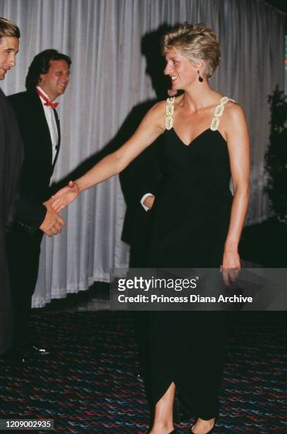 Diana, Princess of Wales meets actor William Baldwin at the London premiere of the film 'Backdraft', 22nd July 1991. She is wearing a black evening...