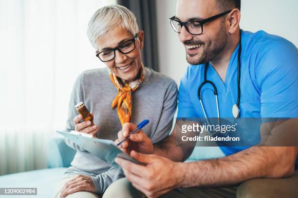 young doctor and senior woman - diabetes pills stock pictures, royalty-free photos & images