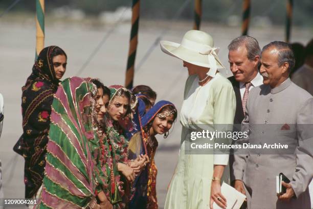 Diana, Princess of Wales visits a school for the deaf in Islamabad, Pakistan, September 1991. She is wearing a pale green dress by Catherine Walker.