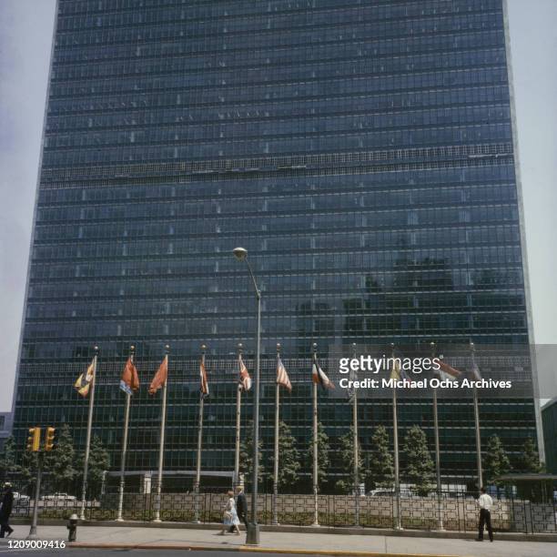 International flags outside the Headquarters of the United Nations in New York City, circa 1965.