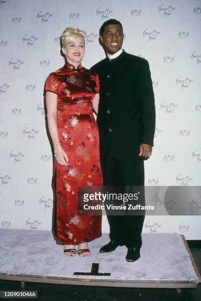 American singer Madonna with Babyface at the 22nd Annual American Music Awards at the Shrine Auditorium, Los Angeles, 30th January 1995.