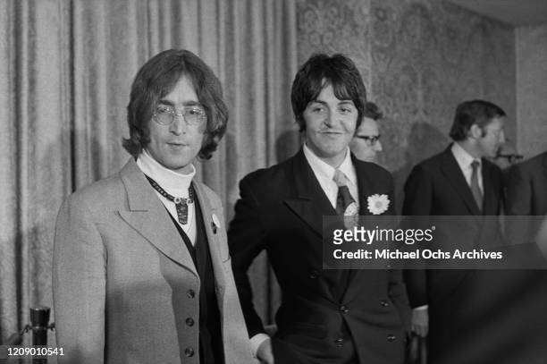 Musicians John Lennon and Paul McCartney of English beat group the Beatles hold a press conference at the Americana Hotel in New York City to...