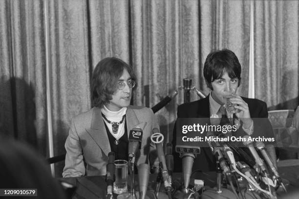 Musicians John Lennon and Paul McCartney of English beat group the Beatles hold a press conference at the Americana Hotel in New York City to...