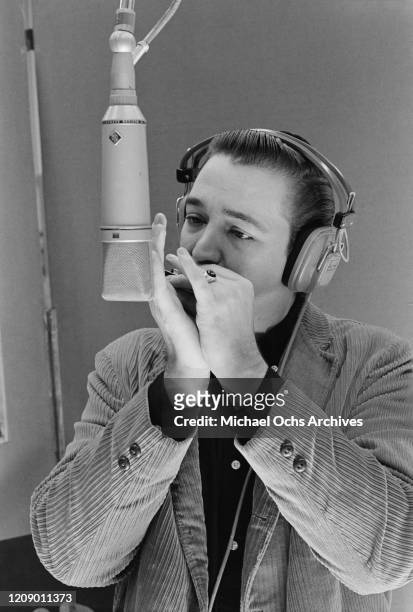 American blues harmonica player Charlie Musselwhite in a recording studio, circa 1970.