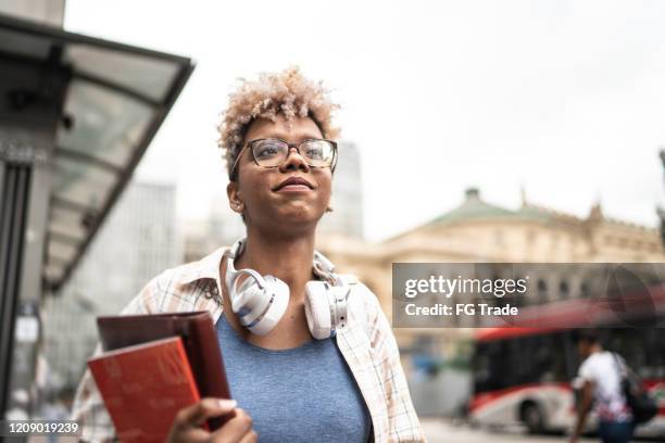 student young woman walking in the city - city book stock pictures, royalty-free photos & images