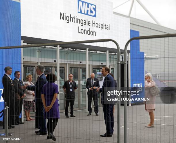 Britain's Health Secretary Matt Hancock reacts as he arrives at the ExCeL London exhibition centre, which has been transformed into the "NHS...