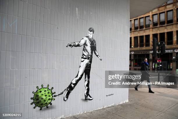 Person walks past a piece of art by the artist, known as the Rebel Bear after it appeared on a wall on Bath Street in Glasgow. The new addition to...