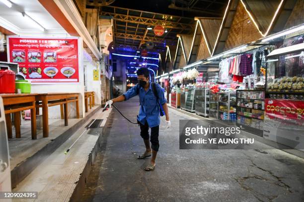 Worker disinfects the food court area as a preventive measure against the spread of the COVID-19 novel coronavirus, at the Yangon-Mandalay highway...