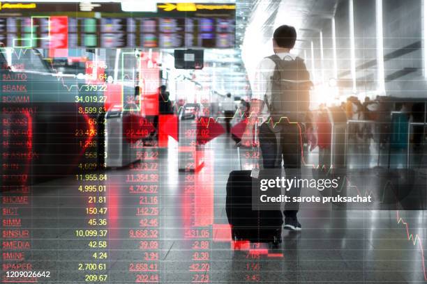 double exposure of  blurred rear view of asian traveler with backpack and suitcase on the airport and stock graph chart in break out trend line to bottom,bearish market and travel concept. - man double exposure profit concept imagens e fotografias de stock