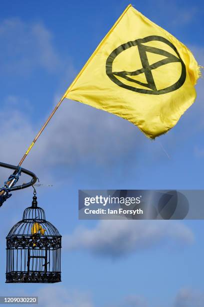An Extinction Rebellion flag flies from a boat that blocks the entrance during a three-day mass action protest at the Bradley Open Cast coal mine on...
