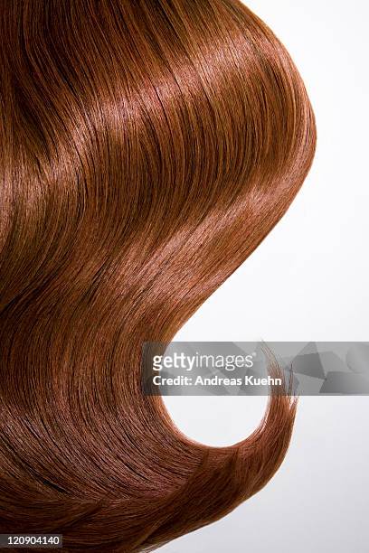 shiny wavy red hair on white background, cropped. - haar stockfoto's en -beelden