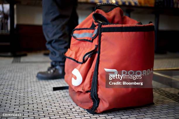 DoorDash Inc. Delivery bag sits on the floor at Chef Geoff's restaurant in Washington, D.C., U.S., on Thursday, March 26, 2020. As the wheels of...