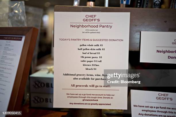 Pantry items for sale, where proceeds go to staff members, hangs on the bar at Chef Geoff's restaurant in Washington, D.C., U.S., on Thursday, March...