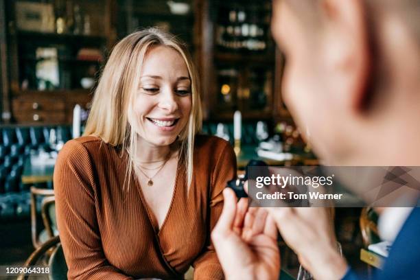 man asking girlfriend to marry him in restaurant - dating show stock pictures, royalty-free photos & images