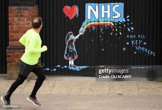 Graffiti depicting the logo of Britain's National Health Service and a rainbow, in an outpouring of love and thanks to NHS staff and key workers...