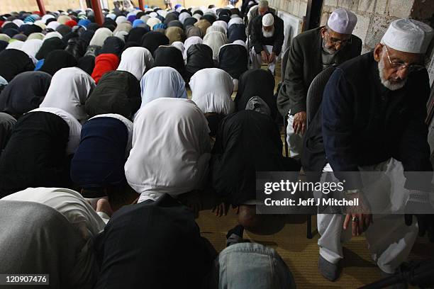 Members of the local Muslim community attend Friday prayers at Dudley Road Mosqueon August 12, 2011 in Birmingham, England. Police are continuing...