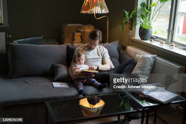 father reading with son - johner images bildbanksfoton och bilder