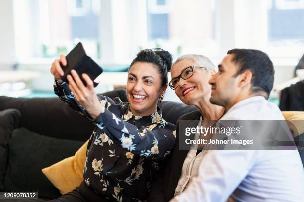 coworkers taking selfie - teambuilding stockfoto's en -beelden