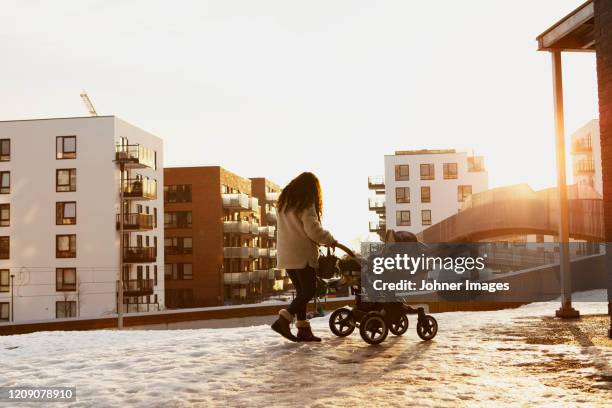 woman walking with pram - oslo people stock pictures, royalty-free photos & images